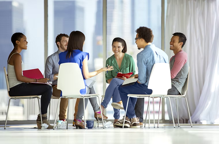 Diverse group of adults in supportive coaching environment